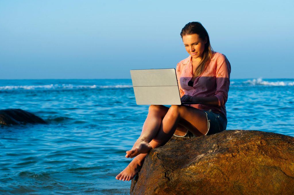 digital nomad working by the sea